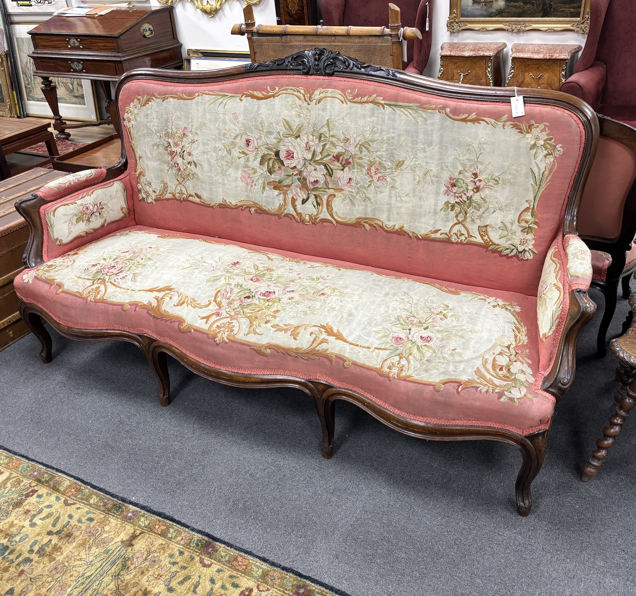 A 19th century French rosewood settee with floral needlepoint upholstery, width 198cm, depth 66cm, height 108cm